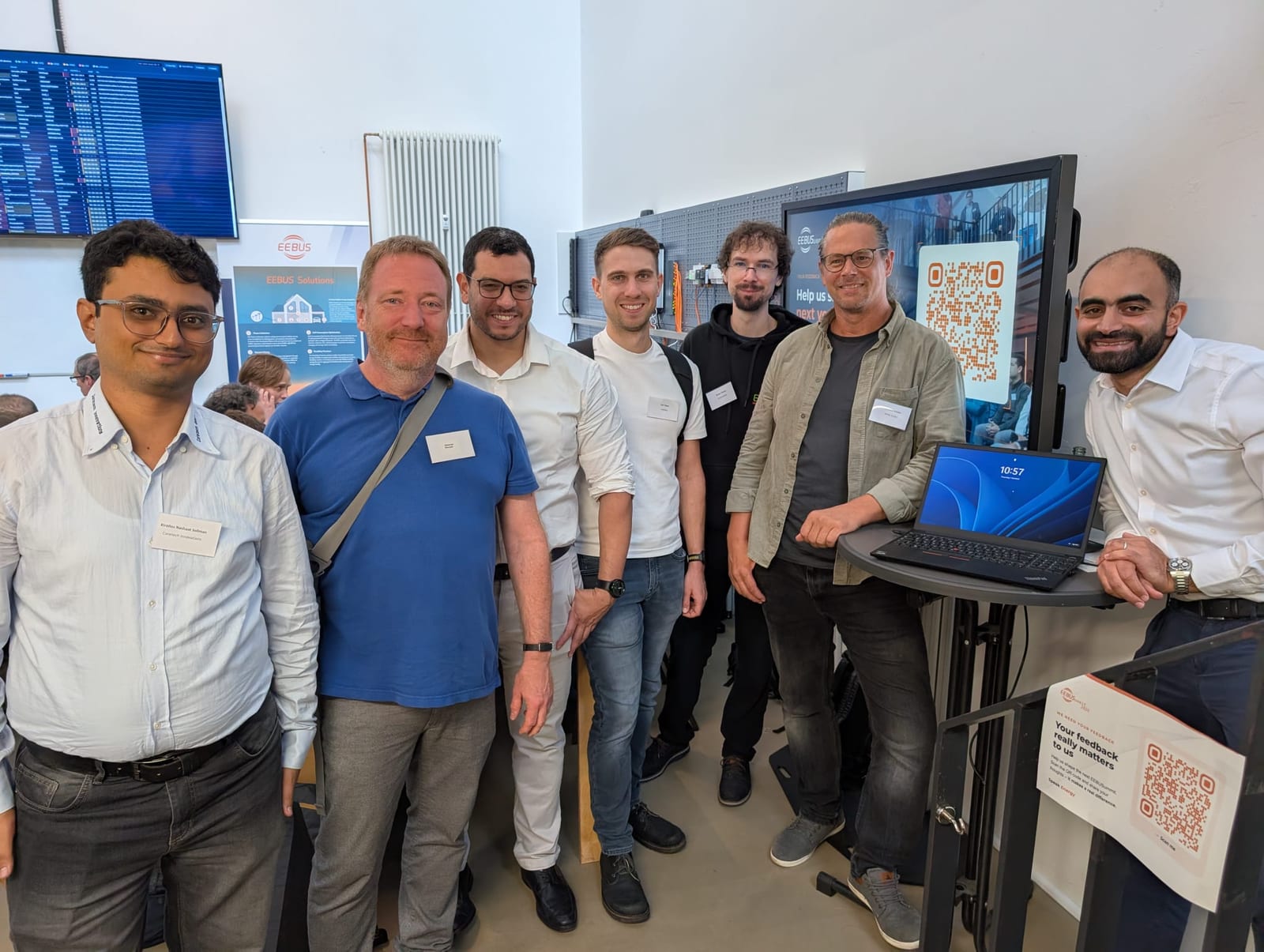 Representatives of Coretech Innovations, EnQS, Kontron eSystems and SPiNE and maintainer Kai Takac at the EEBUS Plugfest 2026 in the Living Lab Cologne, in front of the EEBUS test setup